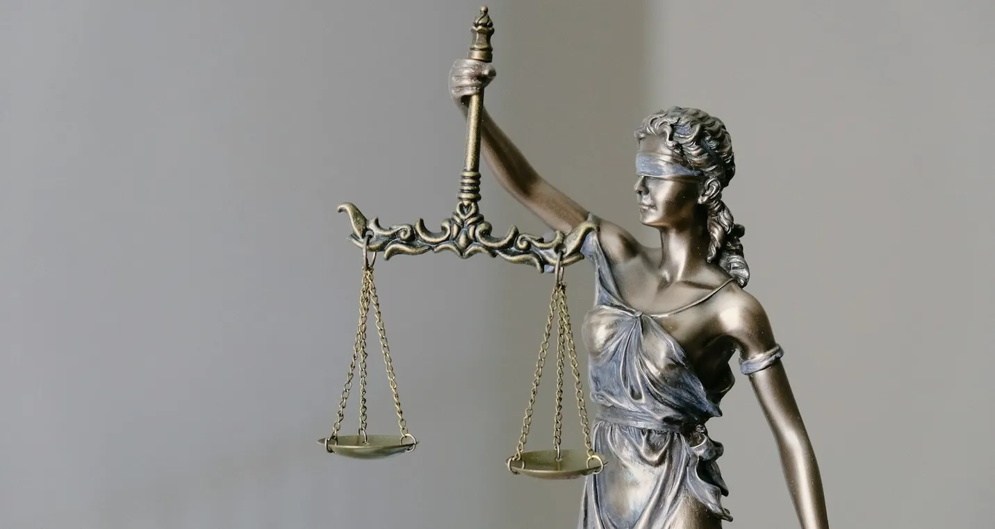 A Statue of Lady Justice holding a sword and scales, symbolizing justice and fairness
