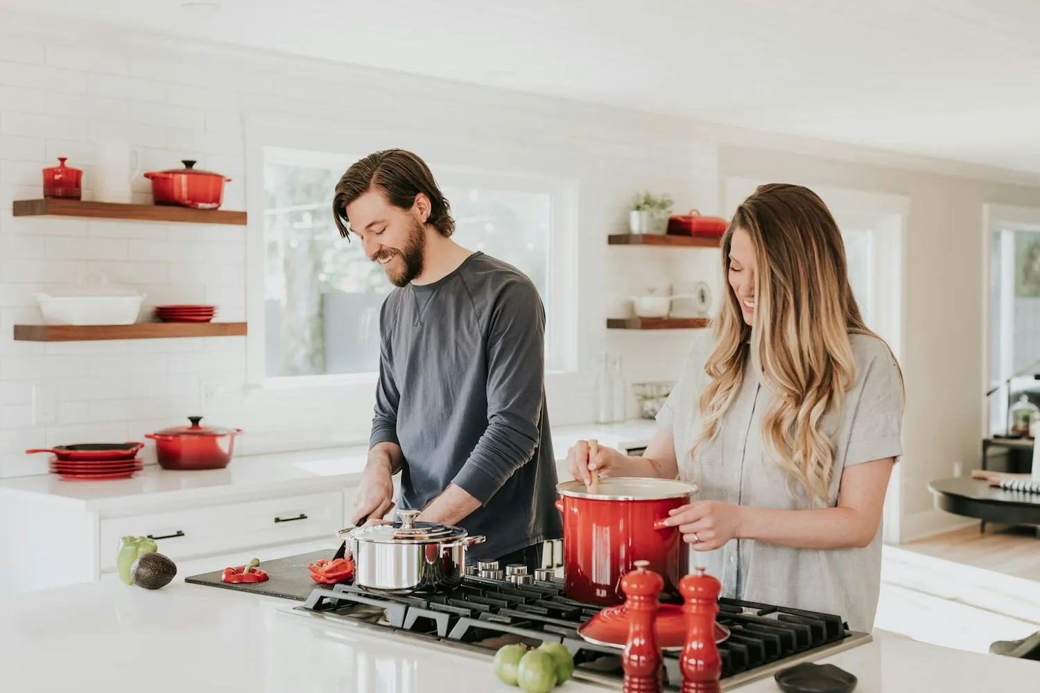 Happy family in front of their new home preparing food in their kitchen.
